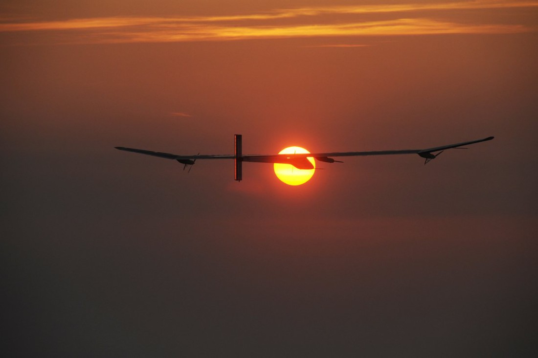 Samolot Solar Impulse 2 na tle zachodzącego Słońca